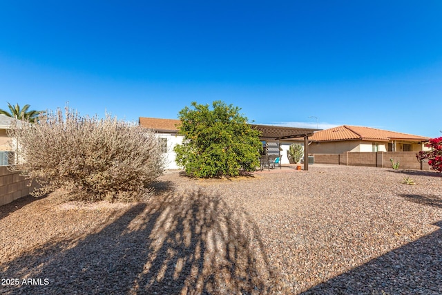 view of front facade featuring a patio area, a fenced backyard, and stucco siding