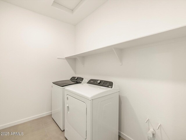 laundry room with washing machine and dryer and light tile patterned flooring