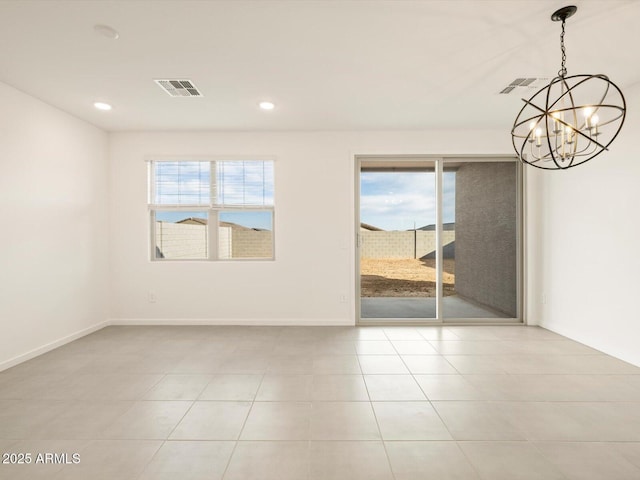 spare room featuring an inviting chandelier, light tile patterned floors, and plenty of natural light