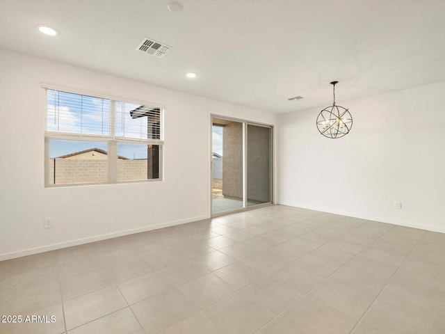 unfurnished room featuring a notable chandelier