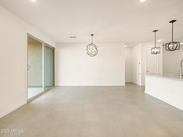 unfurnished room with sink and an inviting chandelier