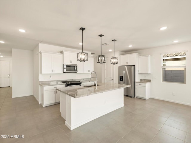 kitchen with appliances with stainless steel finishes, white cabinetry, an island with sink, sink, and hanging light fixtures