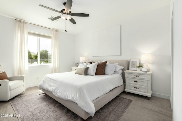 bedroom featuring a ceiling fan, light carpet, and baseboards