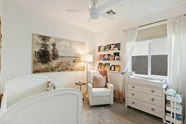 living area featuring a ceiling fan, visible vents, and carpet flooring