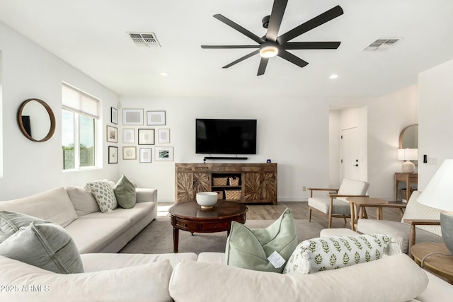 living area featuring ceiling fan, visible vents, wood finished floors, and recessed lighting