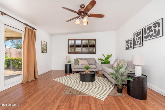 living room featuring ceiling fan, hardwood / wood-style flooring, and lofted ceiling