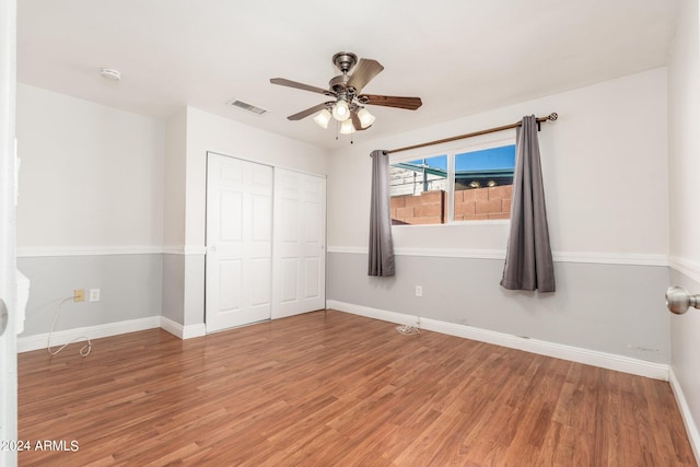 unfurnished bedroom featuring a closet, ceiling fan, and hardwood / wood-style floors