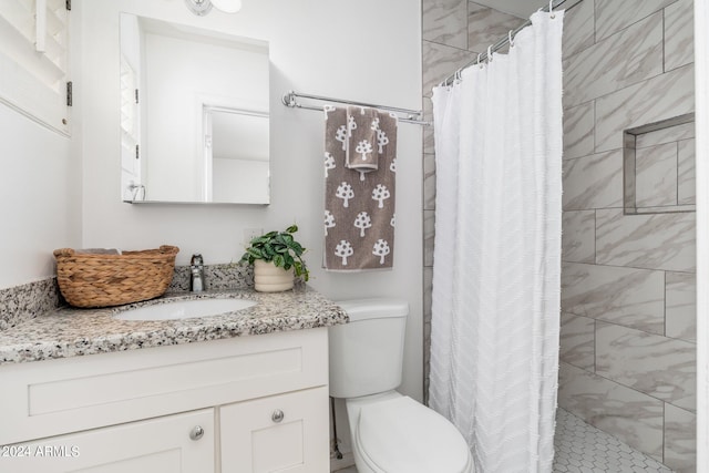 bathroom with vanity, toilet, and walk in shower