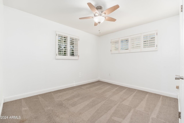 empty room featuring ceiling fan and carpet floors