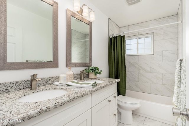 full bathroom featuring vanity, shower / bath combo with shower curtain, and toilet