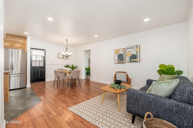 living room featuring a chandelier and light hardwood / wood-style flooring