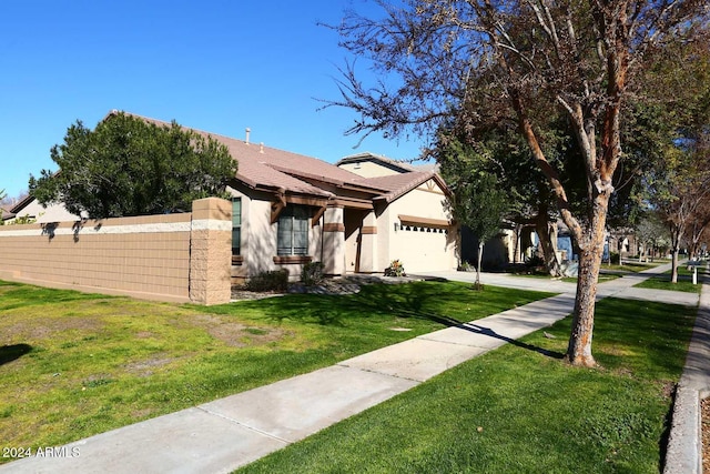 view of front of house with a front lawn and a garage