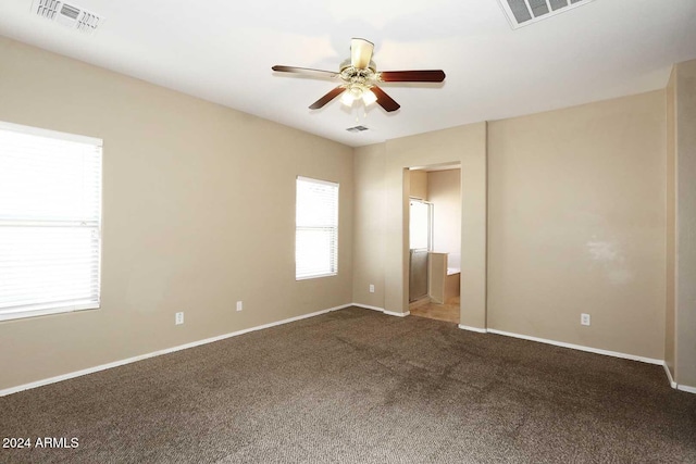 carpeted spare room with ceiling fan