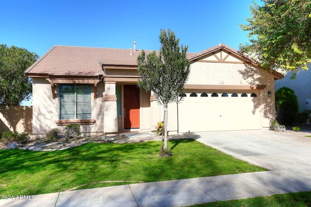 view of front of property with a garage and a front lawn