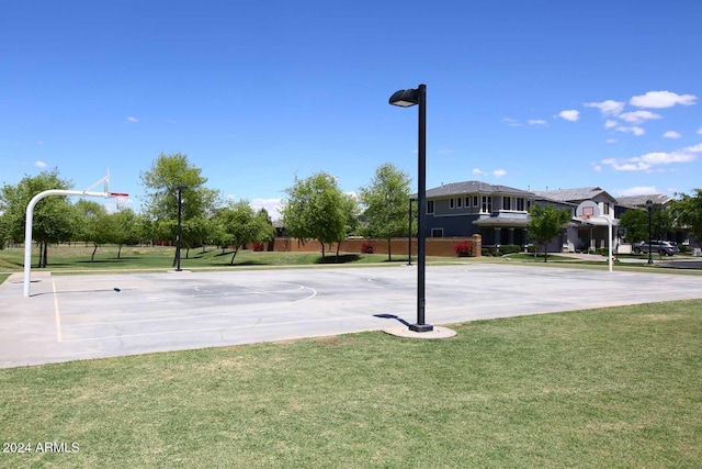 view of basketball court with a lawn