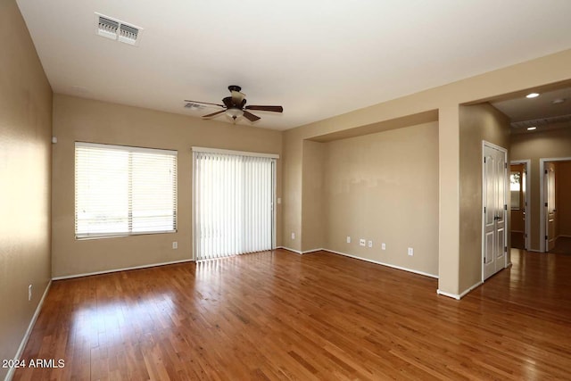 empty room featuring ceiling fan and dark wood-type flooring