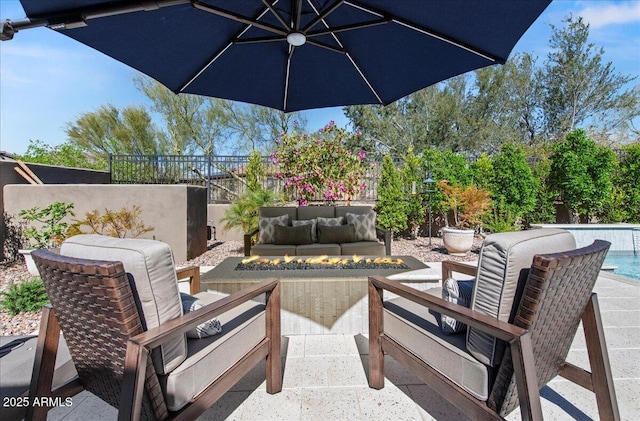 view of patio featuring an outdoor living space, fence, and a fenced in pool