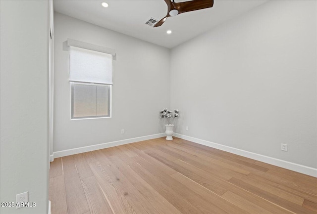 spare room with baseboards, visible vents, light wood-style flooring, and ceiling fan