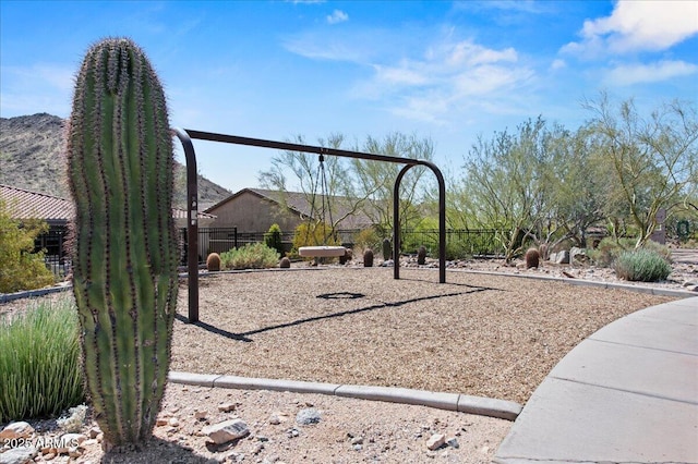 view of playground featuring fence