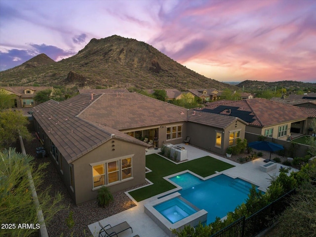 10778 N 137th St, Scottsdale, AZ 85259 - back of property featuring stucco siding, a fenced backyard, a patio area, and a pool with connected hot tub