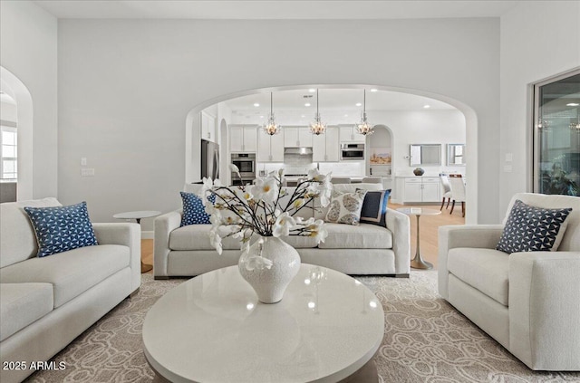 living room with arched walkways and recessed lighting