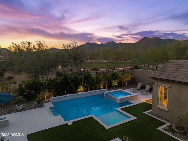 10778 N 137th St, Scottsdale, AZ 85259 - pool at dusk featuring a fenced backyard, a mountain view, a patio area, and a pool with connected hot tub
