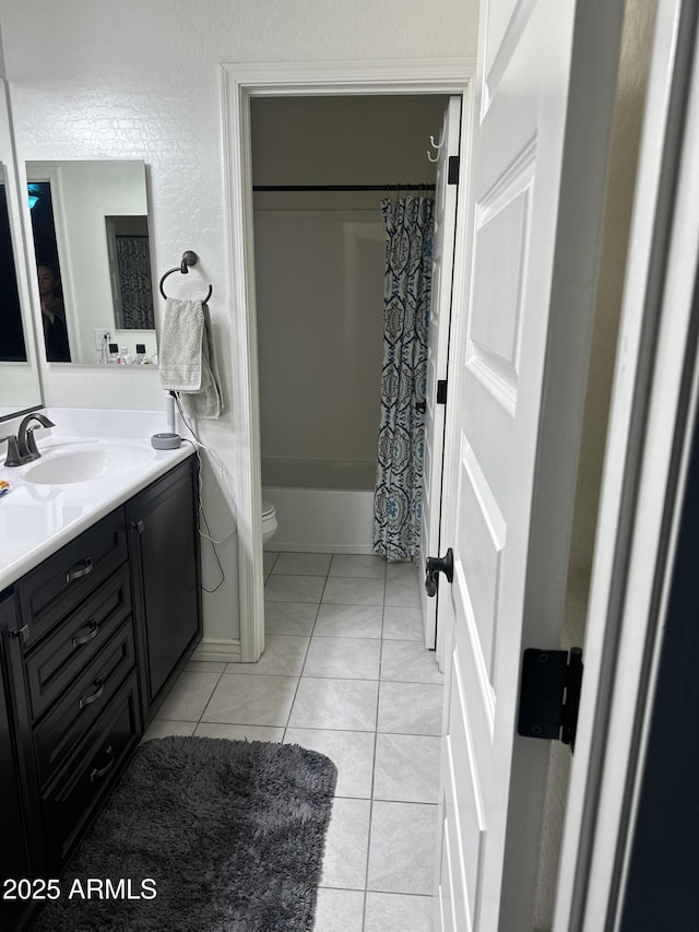 bathroom with a textured wall, toilet, tile patterned flooring, shower / bathtub combination with curtain, and vanity