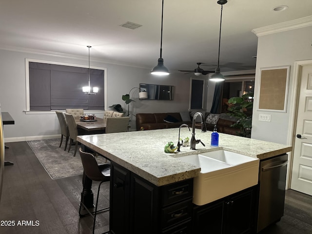 kitchen with ceiling fan, light stone counters, dark wood-style flooring, crown molding, and a sink