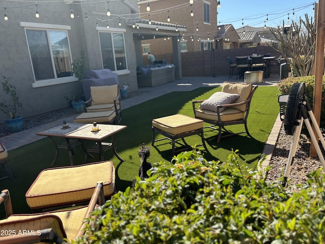 view of yard featuring a patio area, fence, and outdoor dining area