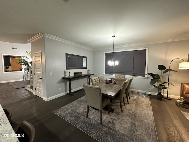 dining space featuring baseboards, ornamental molding, and wood finished floors