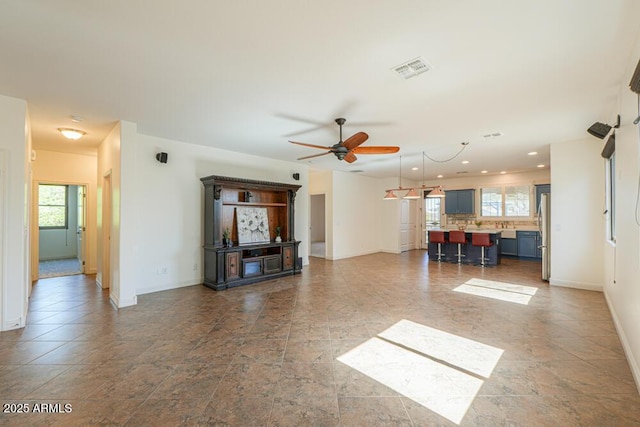 unfurnished living room with visible vents, recessed lighting, baseboards, and ceiling fan