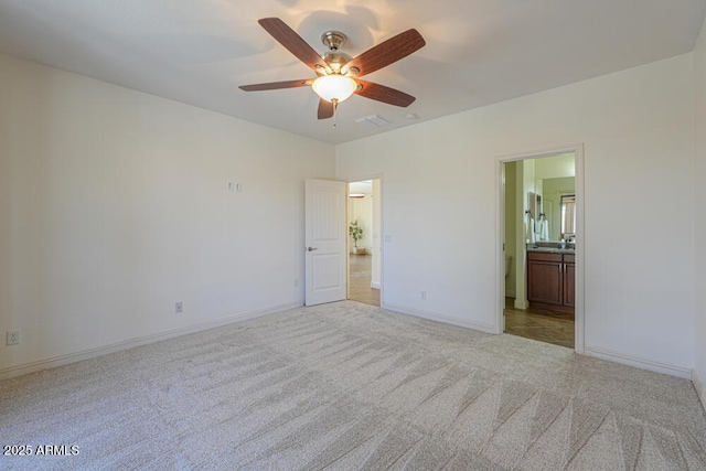 unfurnished bedroom featuring carpet flooring, visible vents, ensuite bathroom, and baseboards