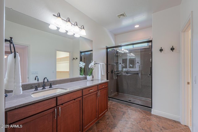 full bathroom with visible vents, baseboards, vanity, and a shower stall