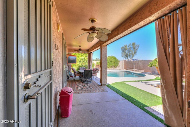 view of patio featuring a fenced backyard, a fenced in pool, and a ceiling fan