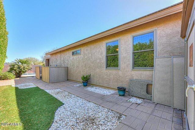 exterior space featuring stucco siding and a patio area