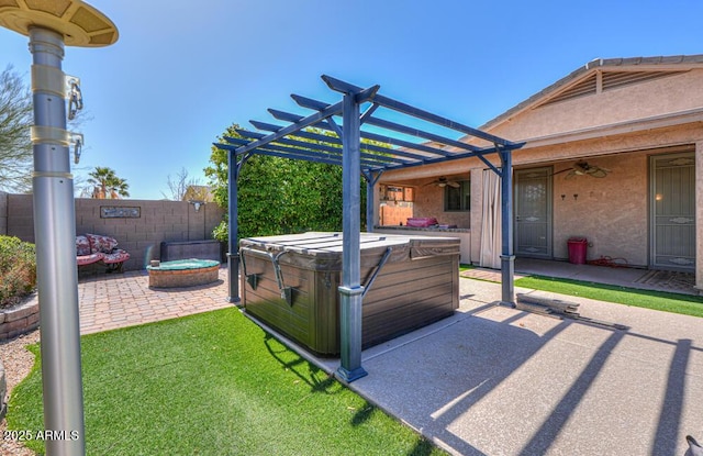 view of patio with ceiling fan, fence, a pergola, and a hot tub