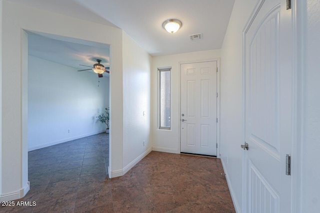 entrance foyer with stone finish floor, baseboards, visible vents, and ceiling fan