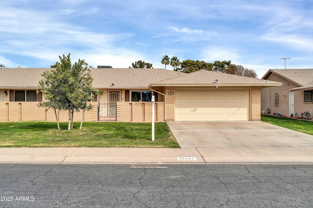 ranch-style home featuring a garage and a front lawn