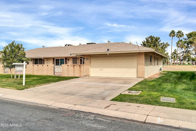 ranch-style home featuring a garage and a front lawn