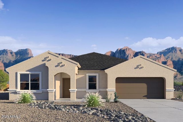 view of front facade featuring a mountain view and a garage