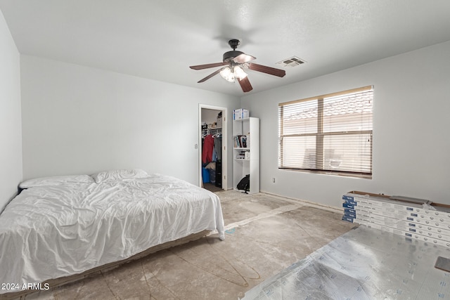 bedroom with a closet, a walk in closet, and ceiling fan