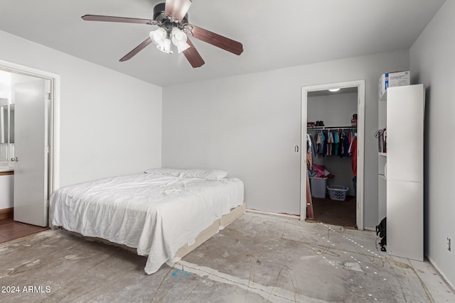 bedroom with a spacious closet, ceiling fan, and a closet