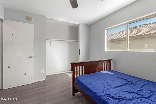 bedroom with a closet, dark hardwood / wood-style floors, and ceiling fan