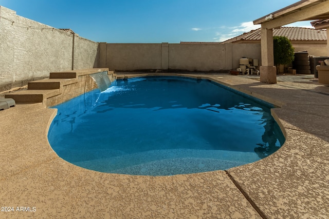 view of pool featuring pool water feature and a patio area