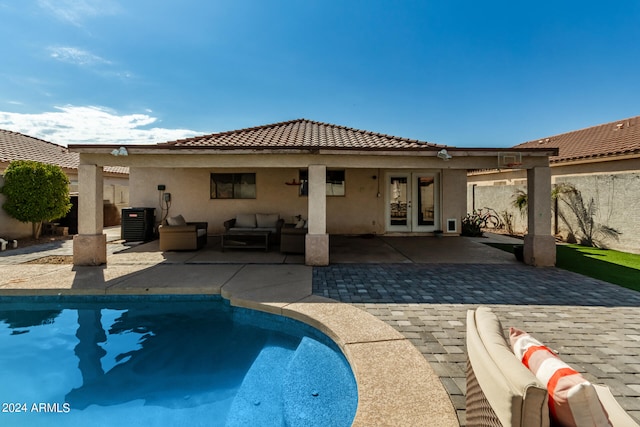 rear view of house with an outdoor hangout area, central air condition unit, french doors, and a patio area