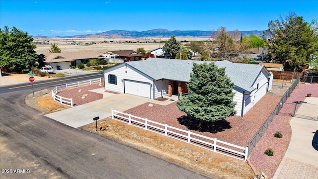 4959 N Indio Cir, Prescott Valley, AZ 86314 - view of front of house with fence, an attached garage, driveway, a mountain view, and a residential view