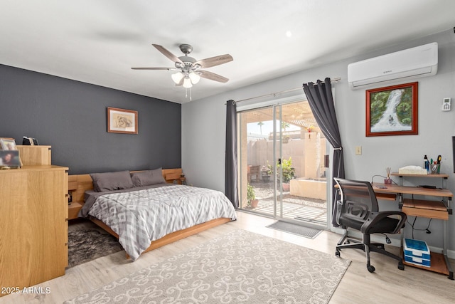 bedroom featuring ceiling fan, access to exterior, a wall mounted AC, and light wood-type flooring