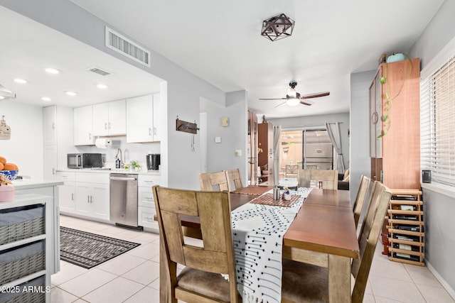 tiled dining space featuring ceiling fan