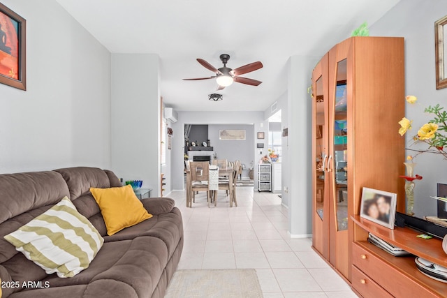 tiled living room with a wall mounted air conditioner and ceiling fan