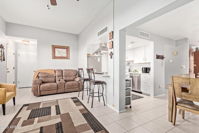 living room with light tile patterned floors and ceiling fan